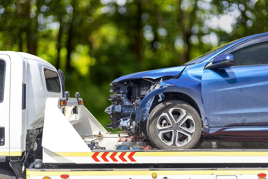 Damaged vehicle on a tow truck following a car accident in Florida