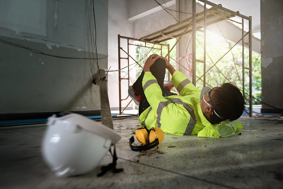 florida construction worker laying on the floor injured after a slip and fall accident on the job